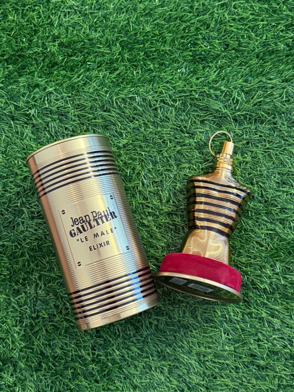 Jean Paul Gaultier Gold and Black Le Male Elixir Bottle with Red Base